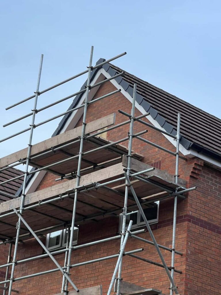 This is a photo of a roof which has just been repaired. There is a scaffold located at the gable end for access onto the roof. Works carried out by Brandon Roofing Repairs