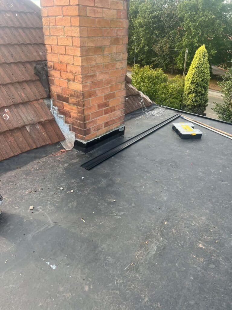 This is a photo of a flat roof which has just been repaired, there is also a chimney stack and some leadwork has also been dressed. Works carried out by Brandon Roofing Repairs